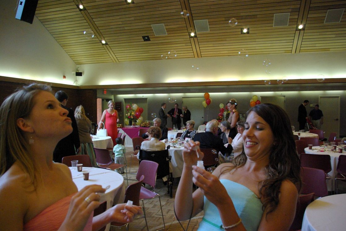 Guests blowing bubbles across the fellowship hall during the reception