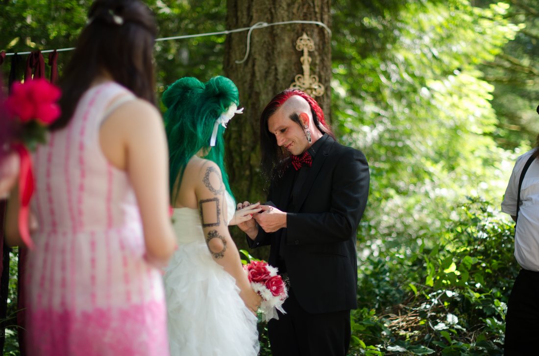 Exchanging rings during the forest ceremony at Oxbow Park