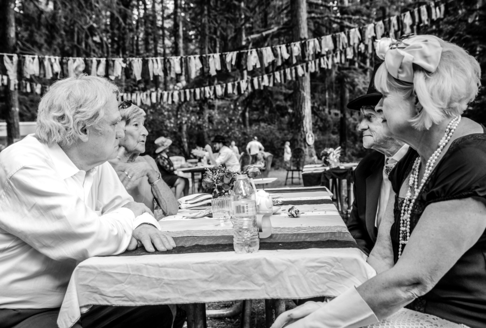 Black and white photo of guests at outdoor wedding reception - Portland event photography